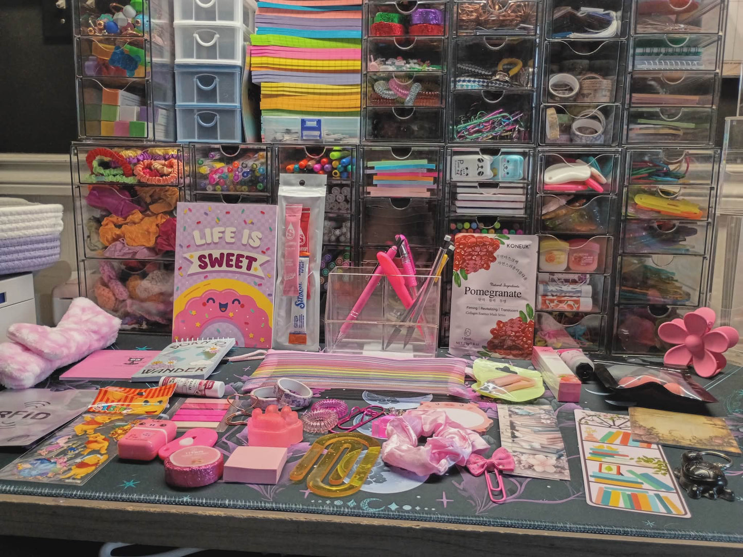 Desk with stationery items and a colorful organizer in the background