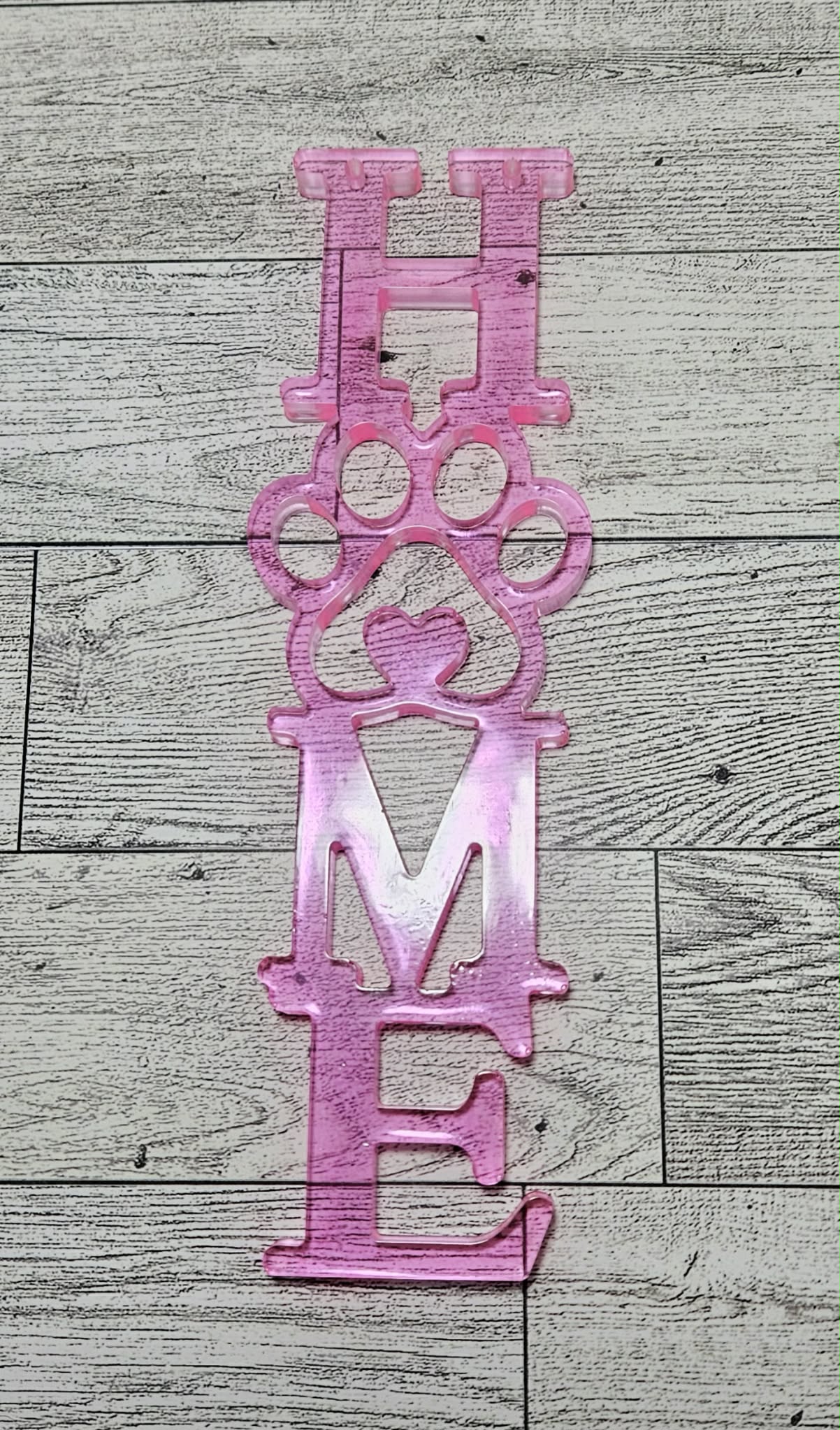 pink home wall decor with pet paw on wood background