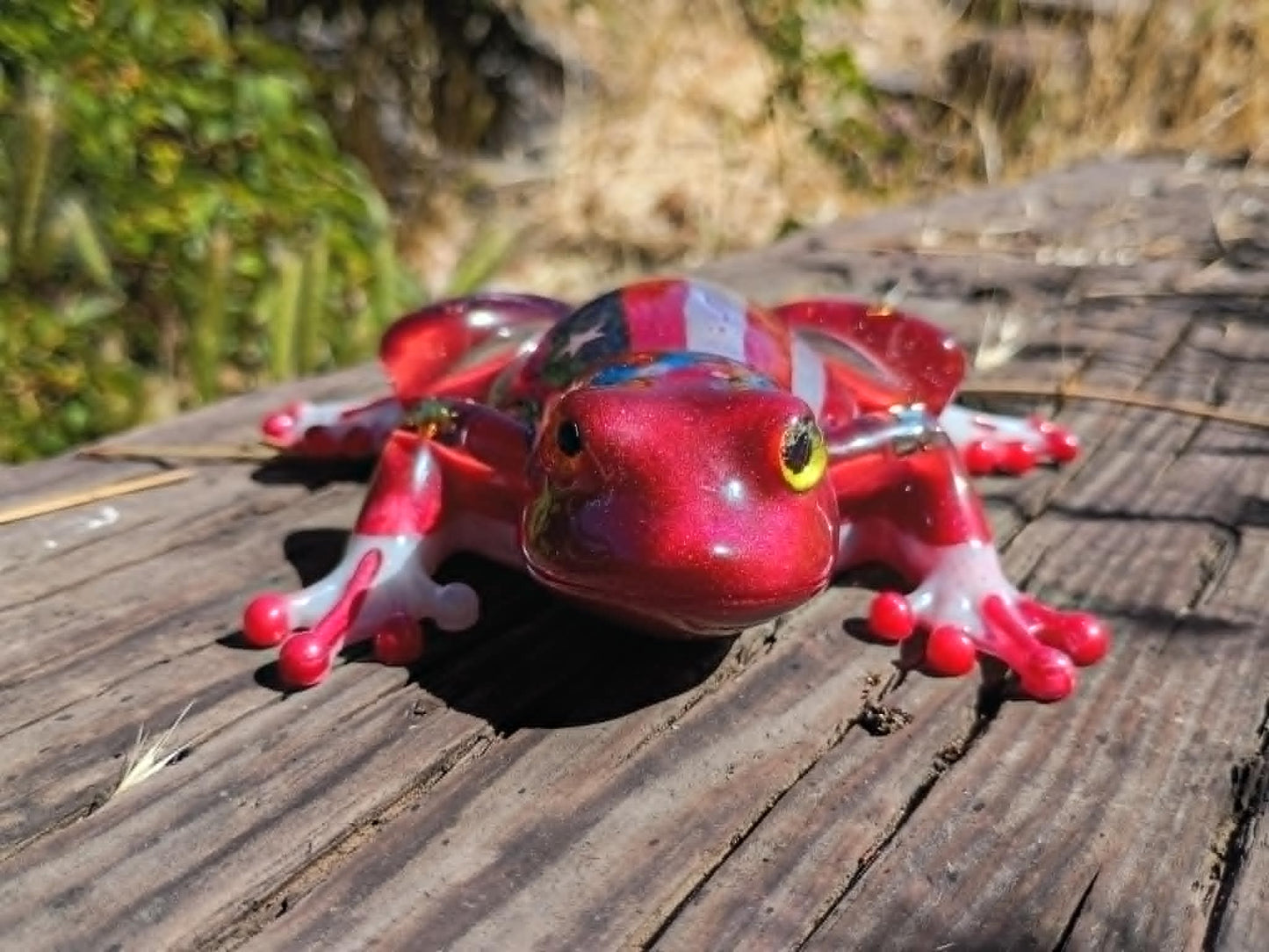 resin frog in wooded background