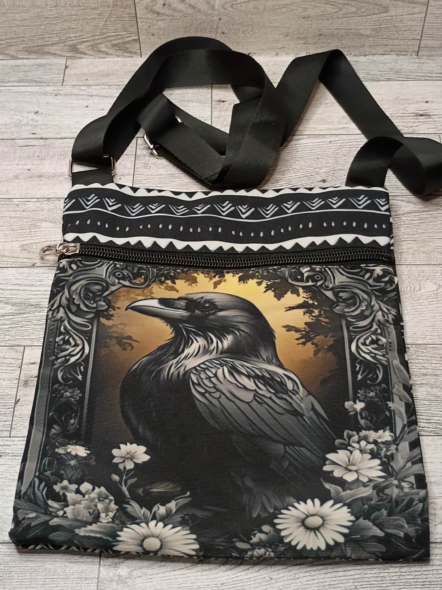 Raven cross body purse on a desk