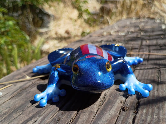 resin frog in wooded background