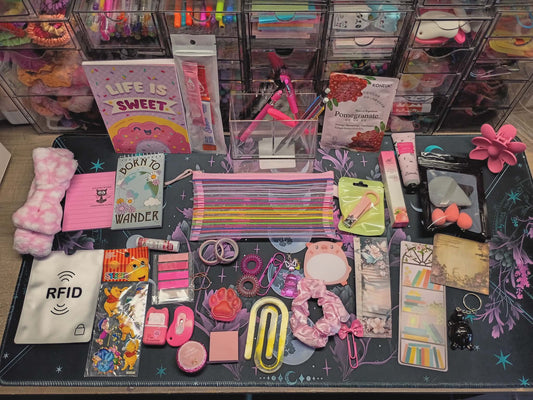 Collection of stationery items on a table with various colors and designs.