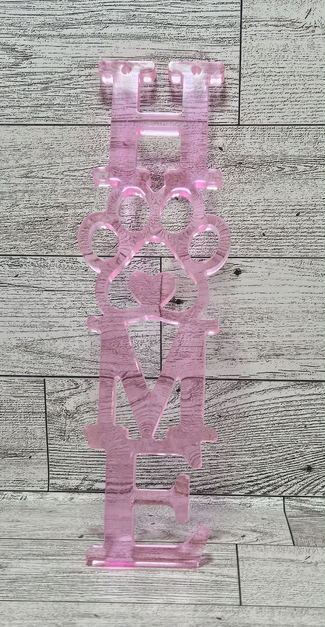 pink home wall decor with pet paw on wood background