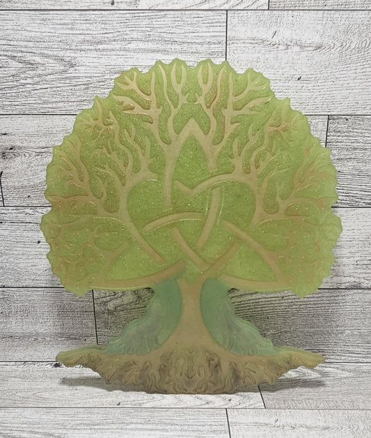 Decorative wall art of a tree with intricate details on a wooden surface
