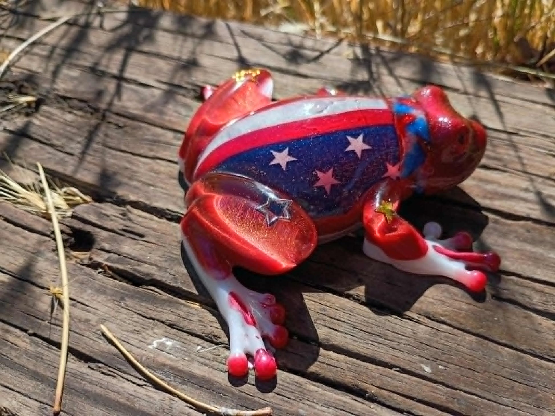 resin frog in wooded background