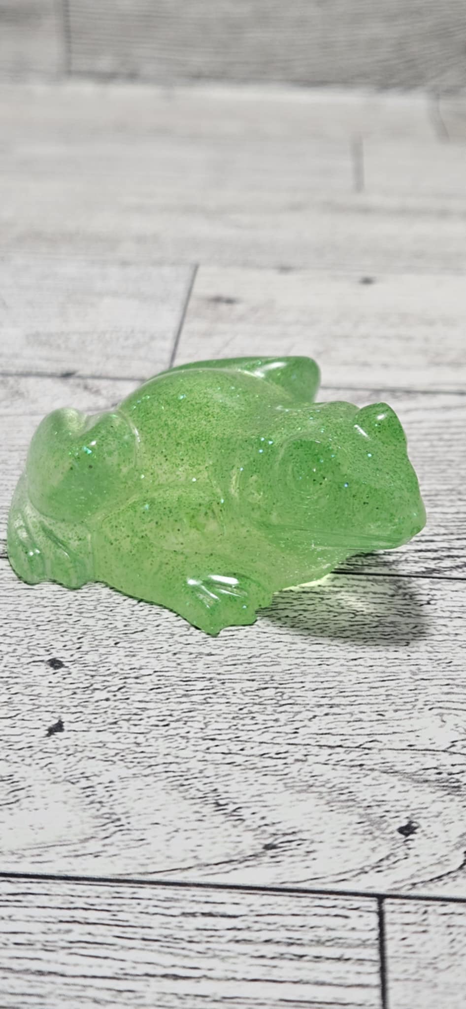 Green jelly-like substance on a wooden surface
