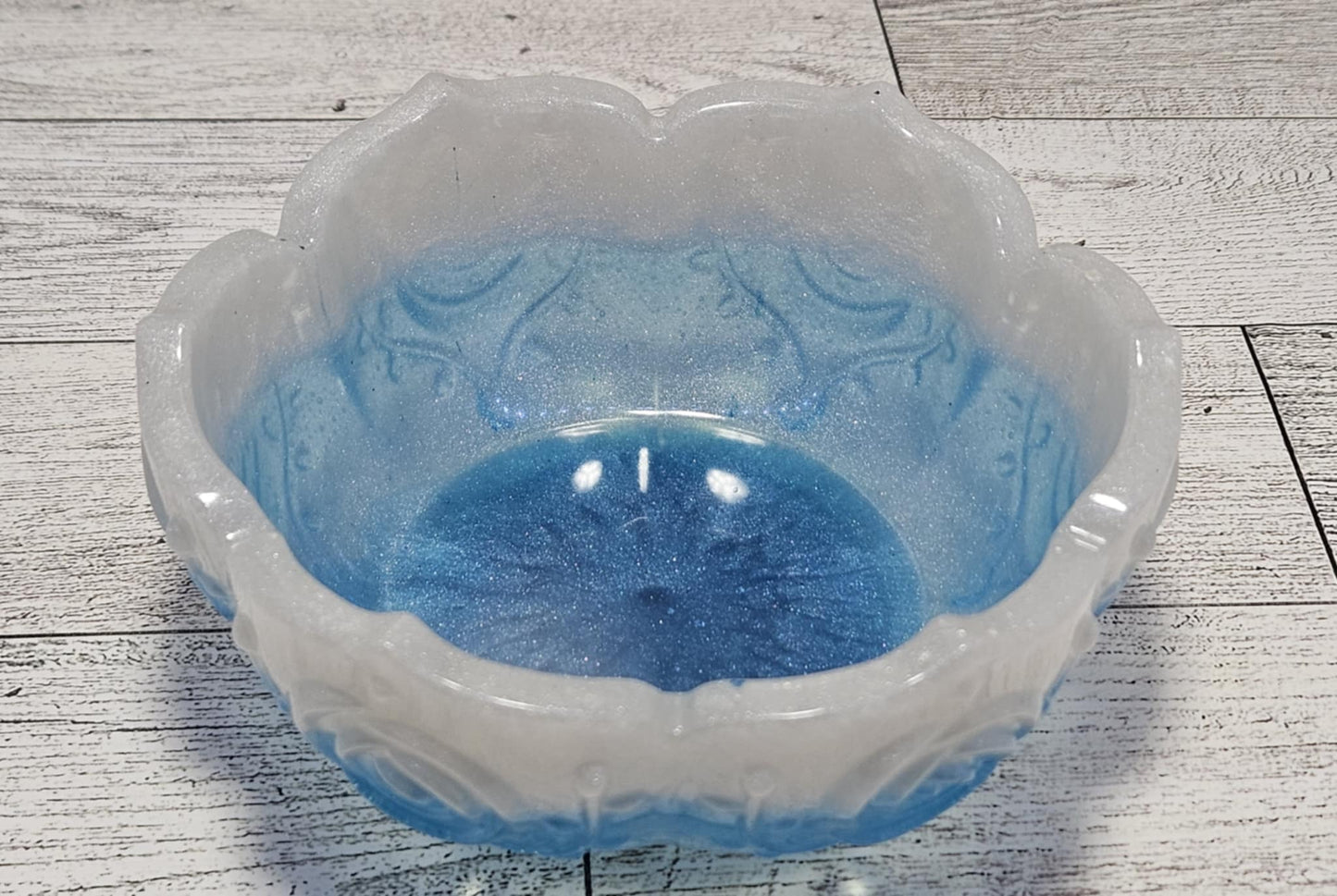Decorative bowl with blue interior on a wooden surface
