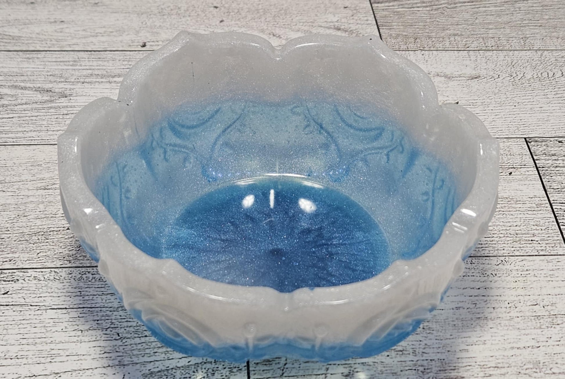 Decorative bowl with blue interior on a wooden surface