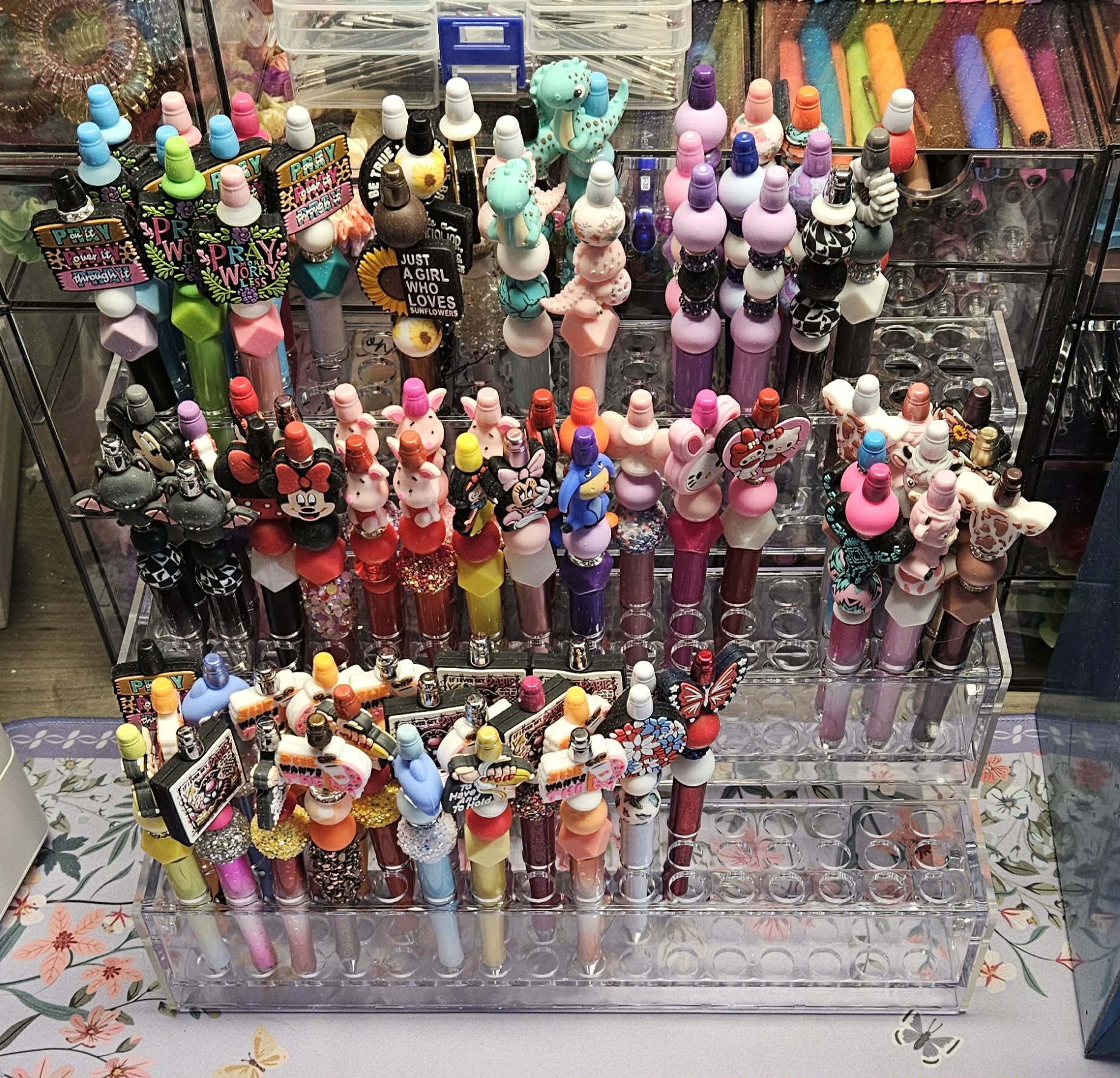 Collection of colorful lip balm figurines in a display case.