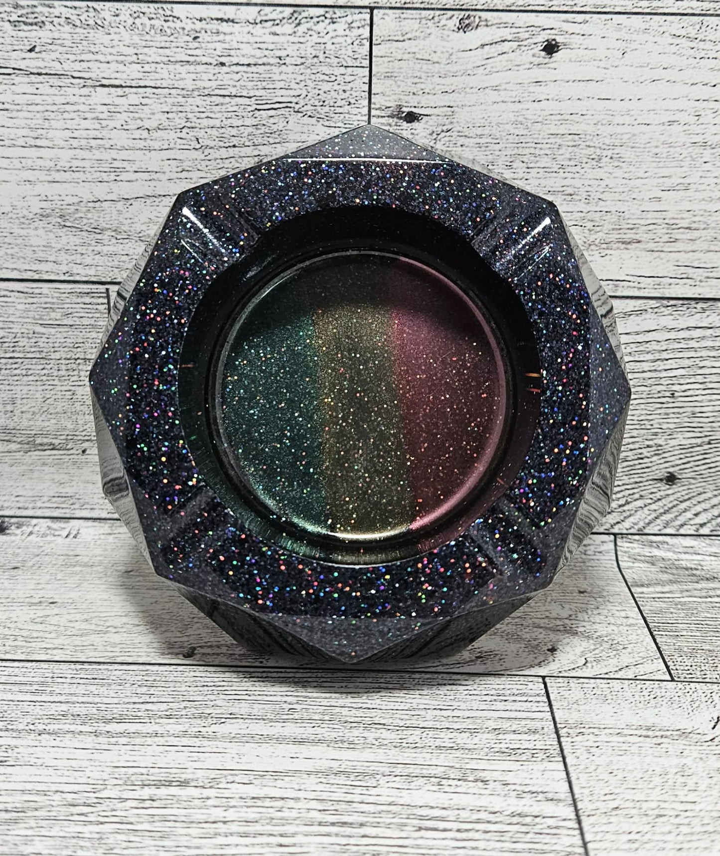 Hexagonal glittery ashtray on a wooden surface