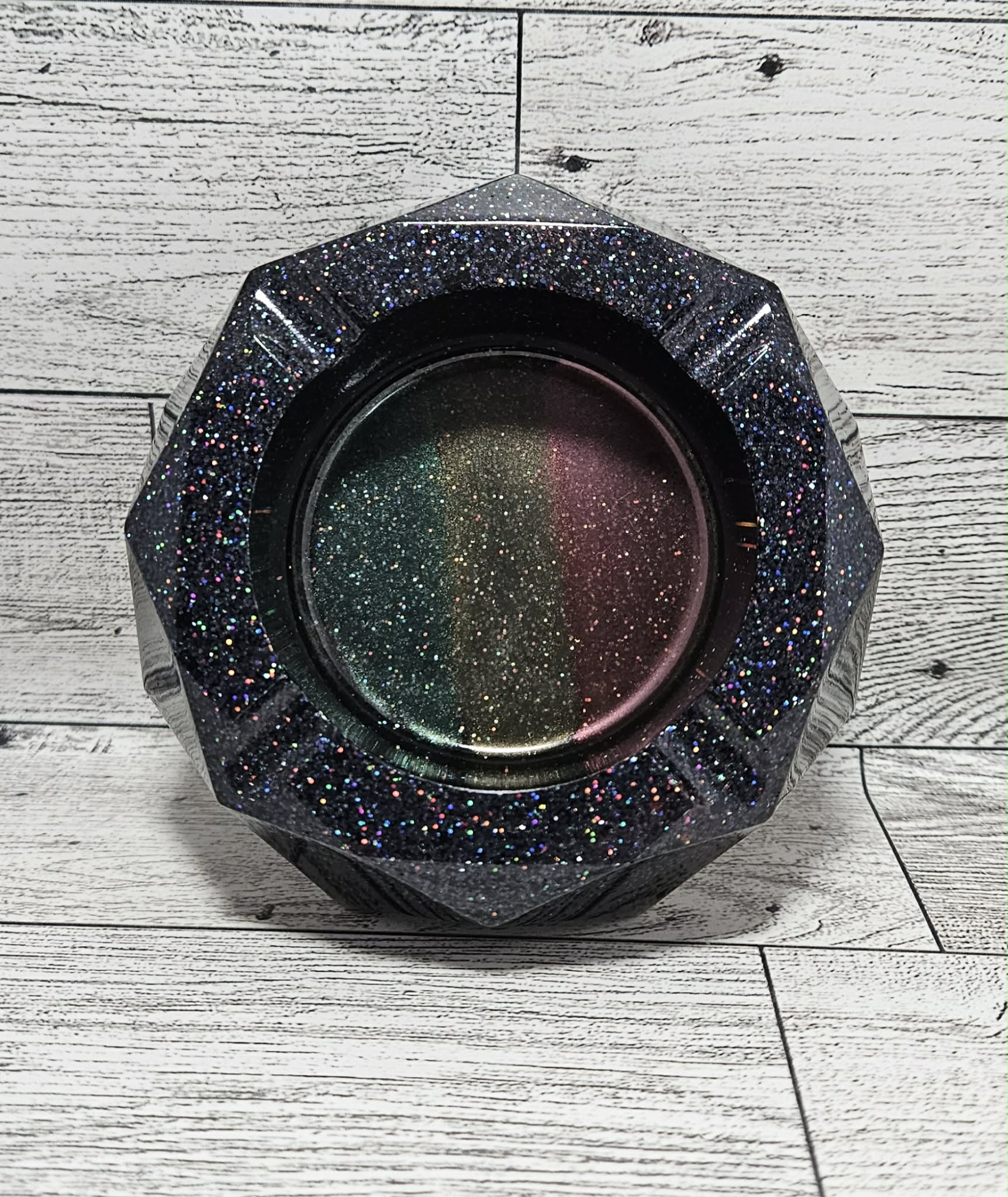 Hexagonal glittery ashtray on a wooden surface