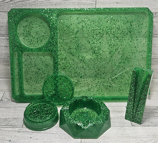 Green speckled plastic trays and containers on a wooden surface