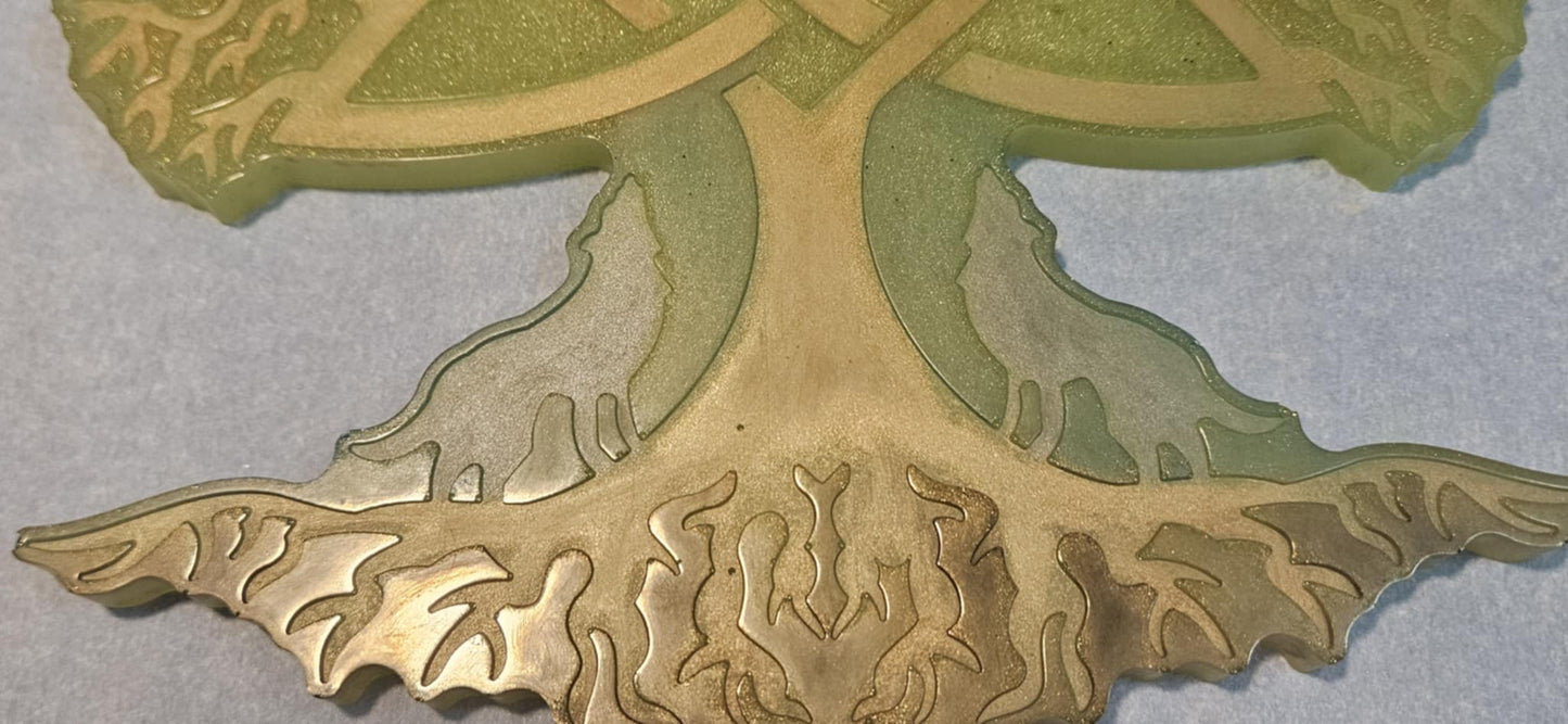 Decorative wall art of a tree with Celtic knot design closeup on light blue surface