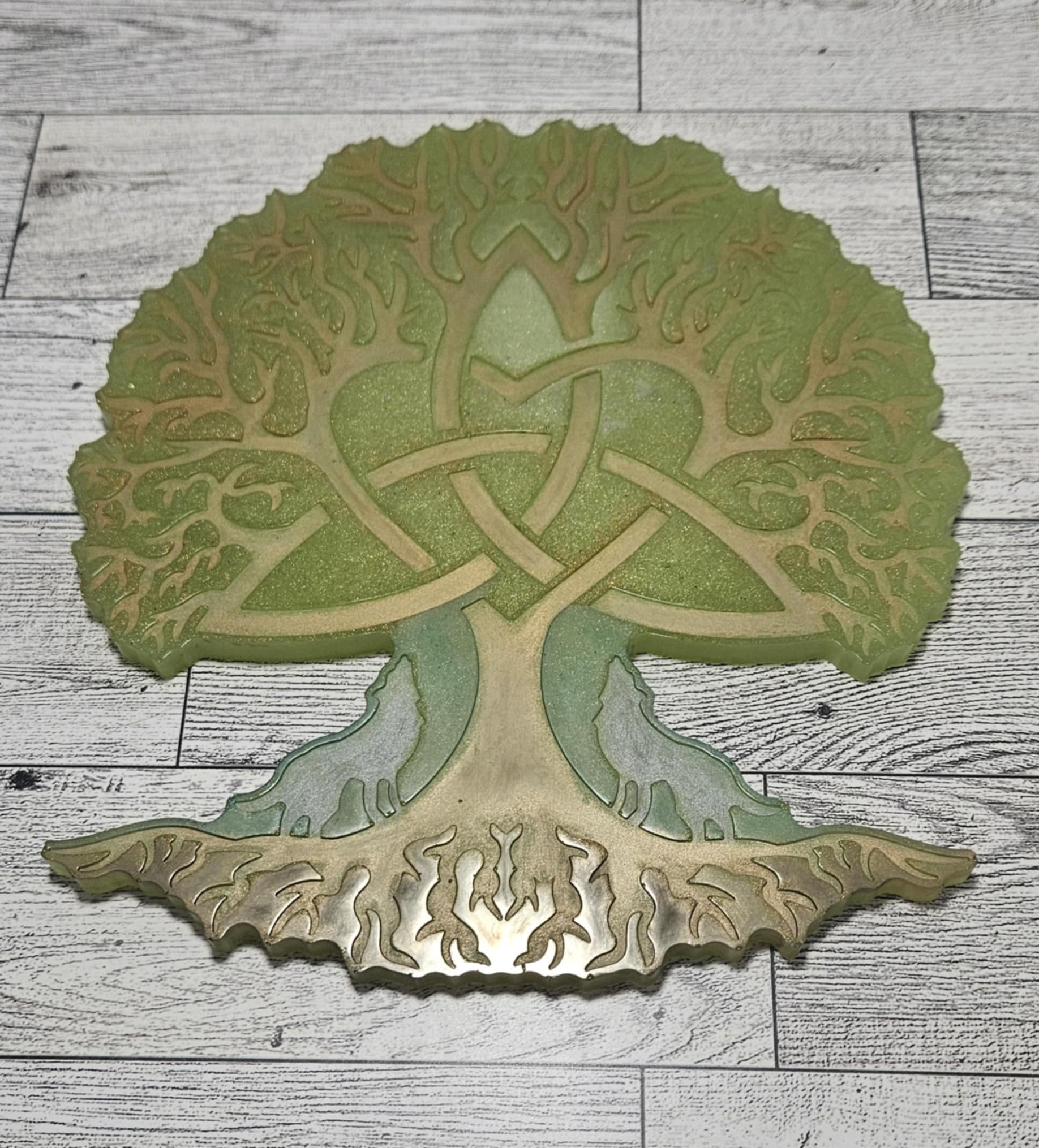 Decorative wall art of a tree with Celtic knot design on a wooden surface