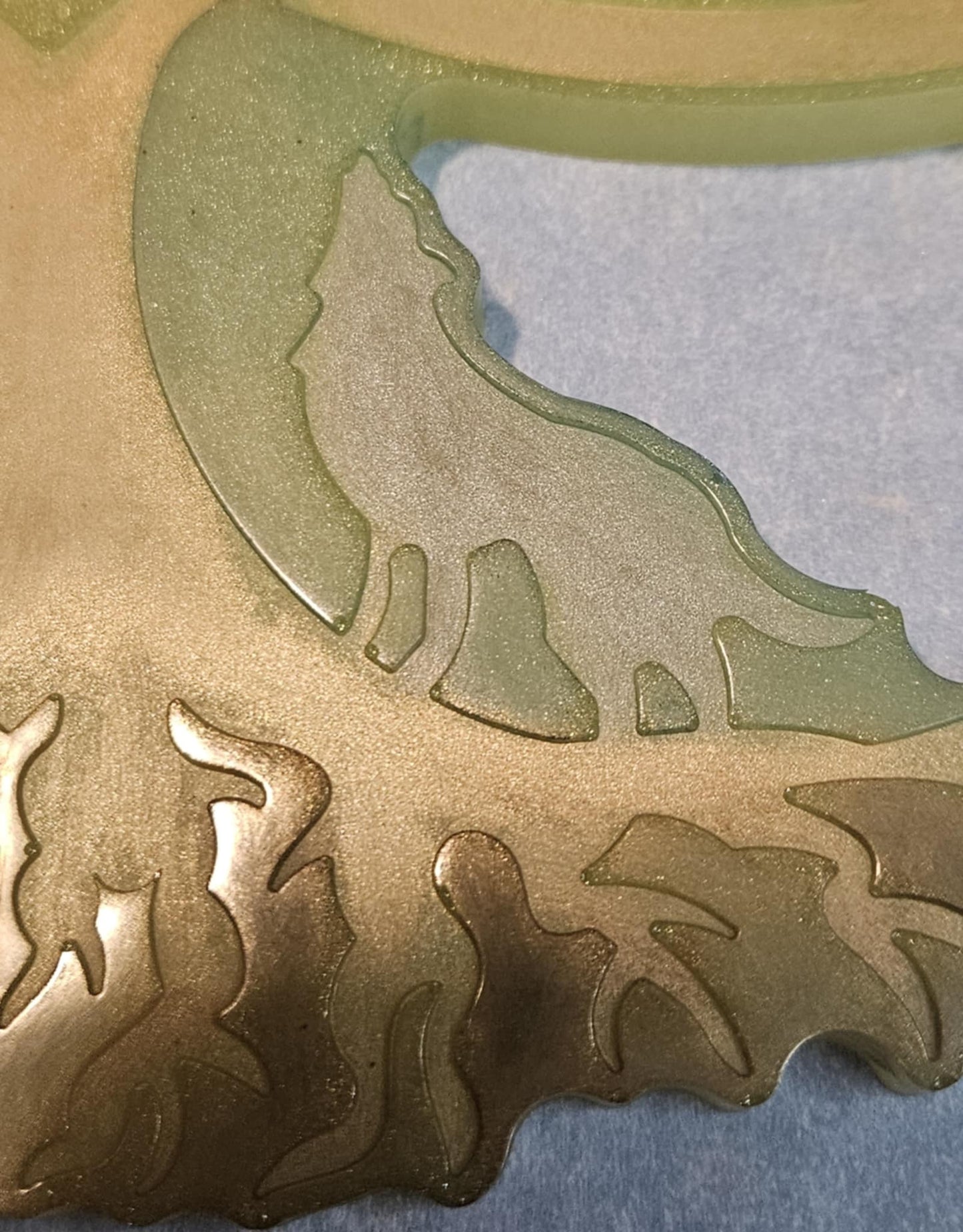 gold and green  tree of life wall decor on a blue background closeup of wolf