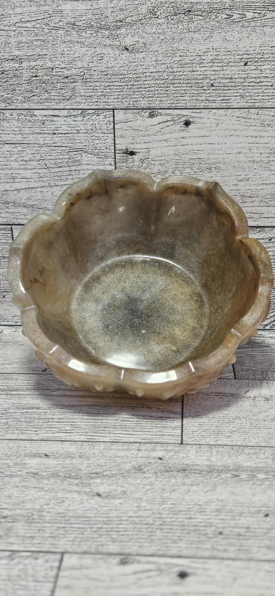 Brown resin bowl on a wooden surface