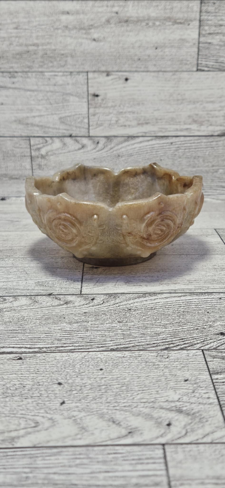 Decorative stone looking resin bowl on a wooden surface