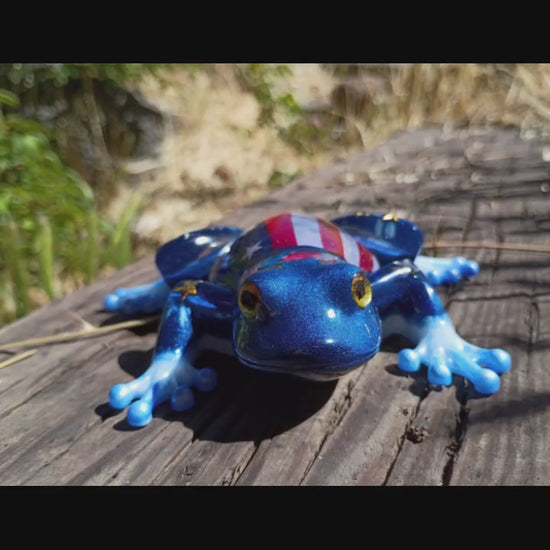 resin frog in wooded background