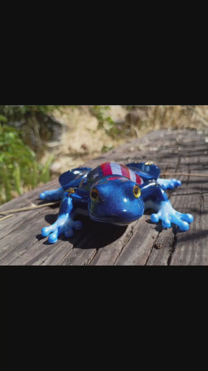 resin frog in wooded background