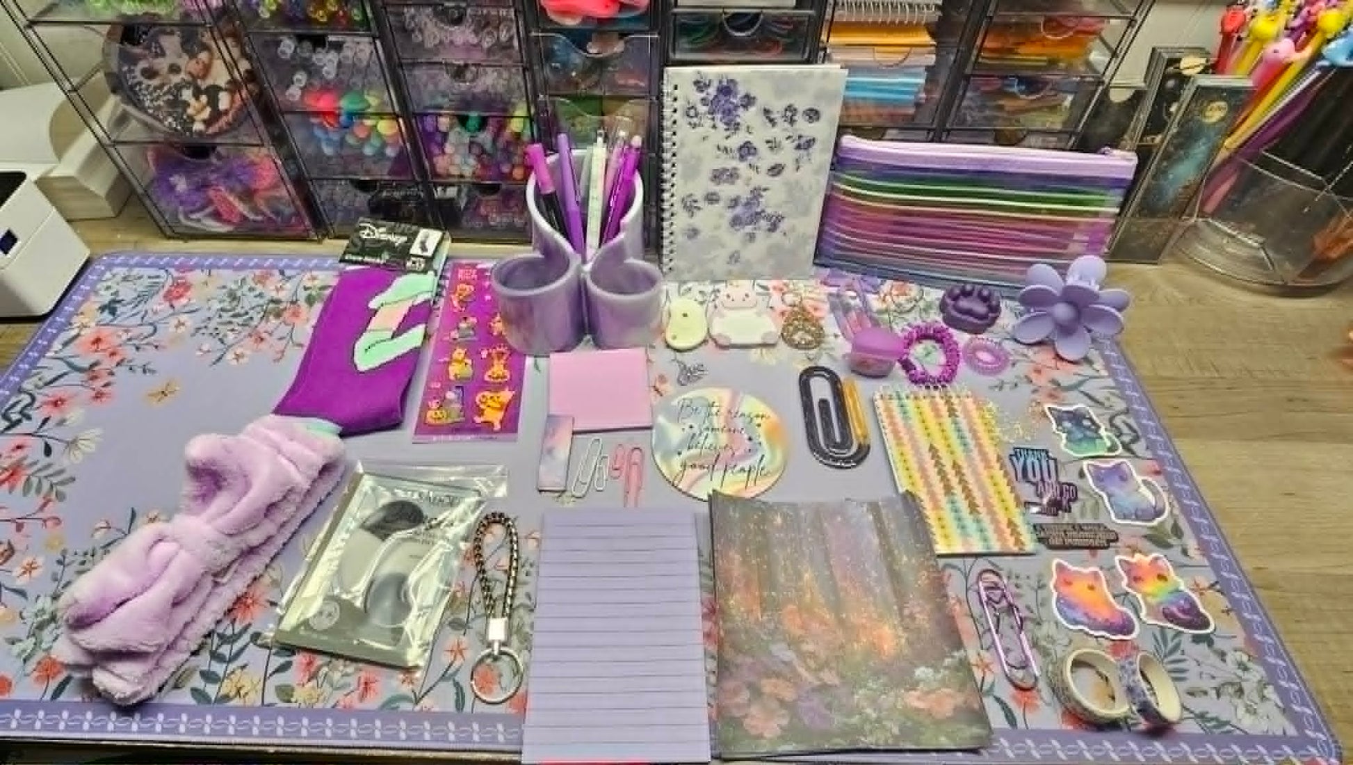 Collection of stationery items on a floral-patterned mat
