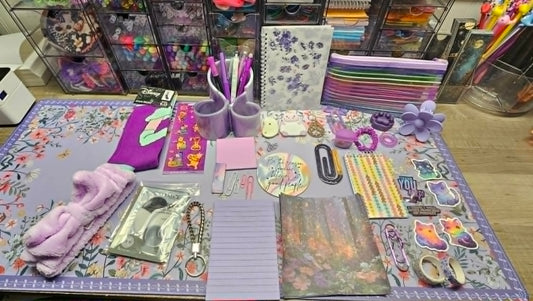 Collection of stationery items on a floral-patterned mat