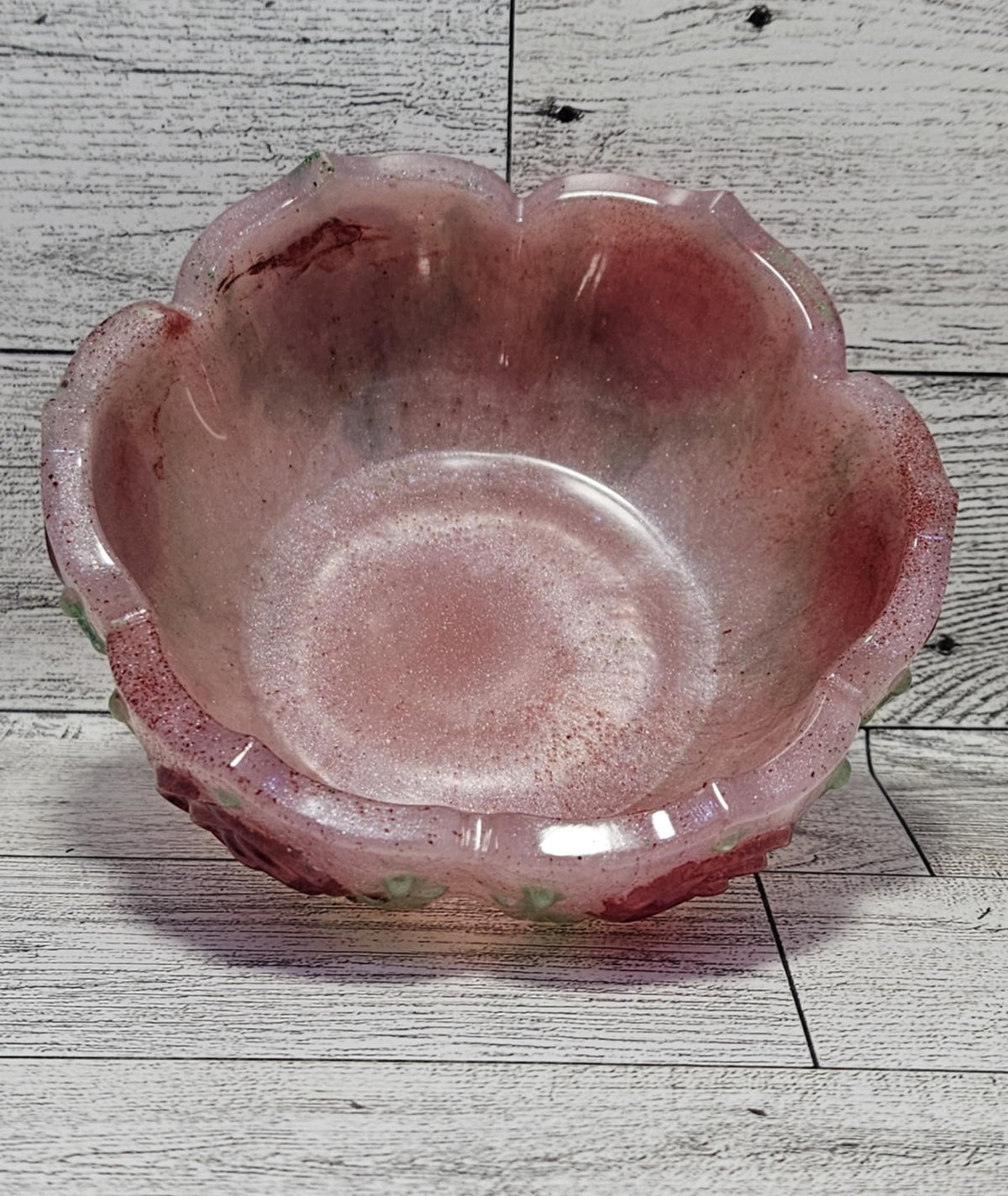 Pink glass bowl on a wooden surface